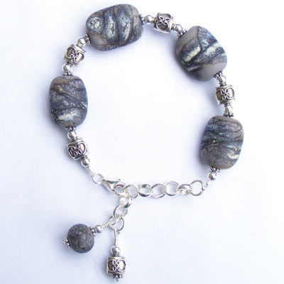 Handmade bracelet with lampwork beads and fair trade Karen Hill tribe sterling silver beads